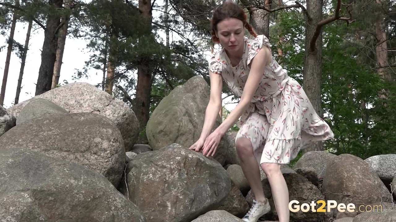 Skinny Girl Jeanna Shows Her Bush While Taking A Piss Atop Some Boulders