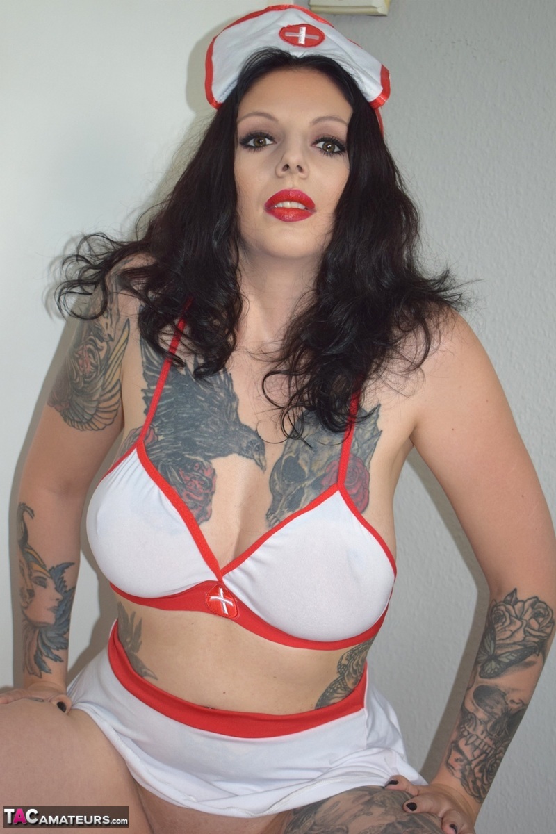 Tattooed brunette Lucy Ravenblood takes off naughty nurse attire on a bed porno fotoğrafı #426240783