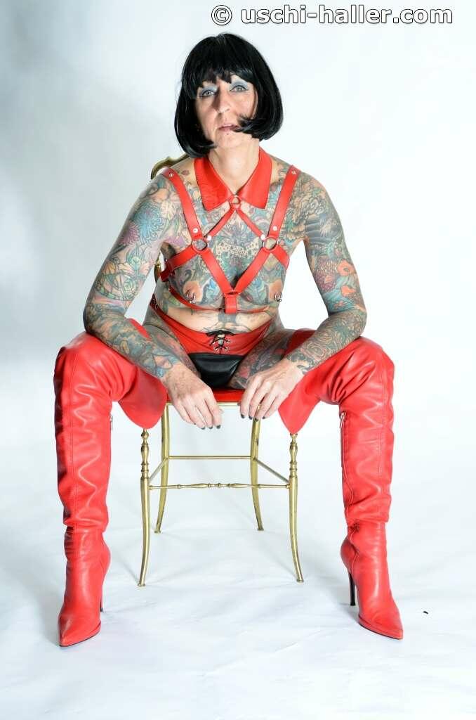Solo Girl Tattoogirl Cleo Models A Bondage Harness In Thigh High Boots