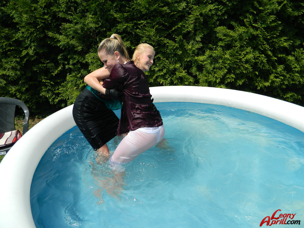 Clothed lesbians get soaking wet after getting into an above-ground pool porno foto #428457822
