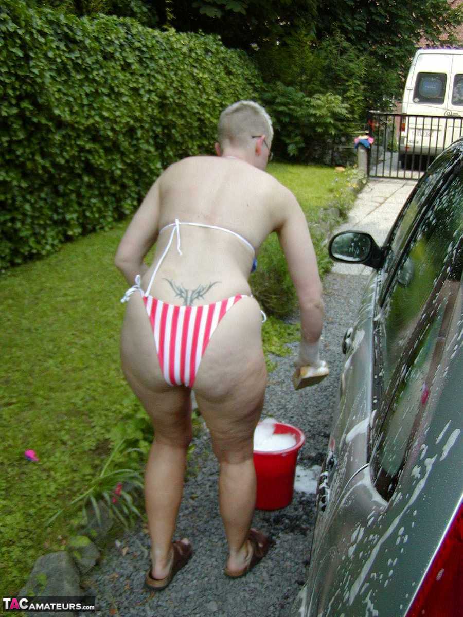 Older Blonde Tiffany Pearl Washes Her Car While Wearing A Bikini