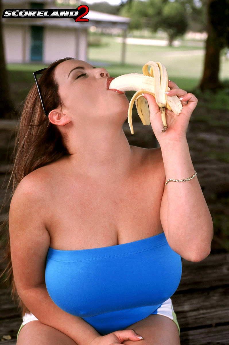 Thick chick Annie Swanson eats a banana before baring her breasts in a park porn photo #427212745