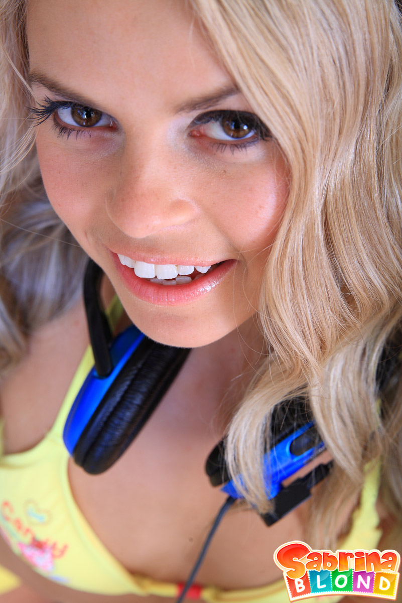 Cute teen Sabrina Blond takes off bikini top and shorts with her headset on porn photo #423597085