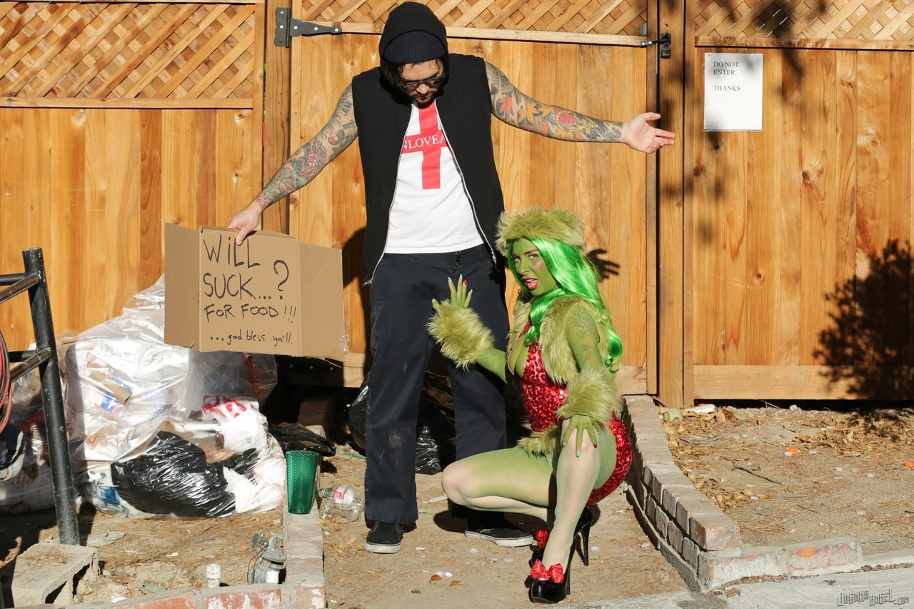 A tattooed cosplay fetish named Joanna Angel takes on a large anal piece while performing outside in a hobo enclosure.