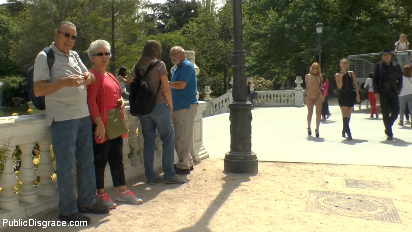 Prior to being gangbanged, a naked girl is shown walking in public.