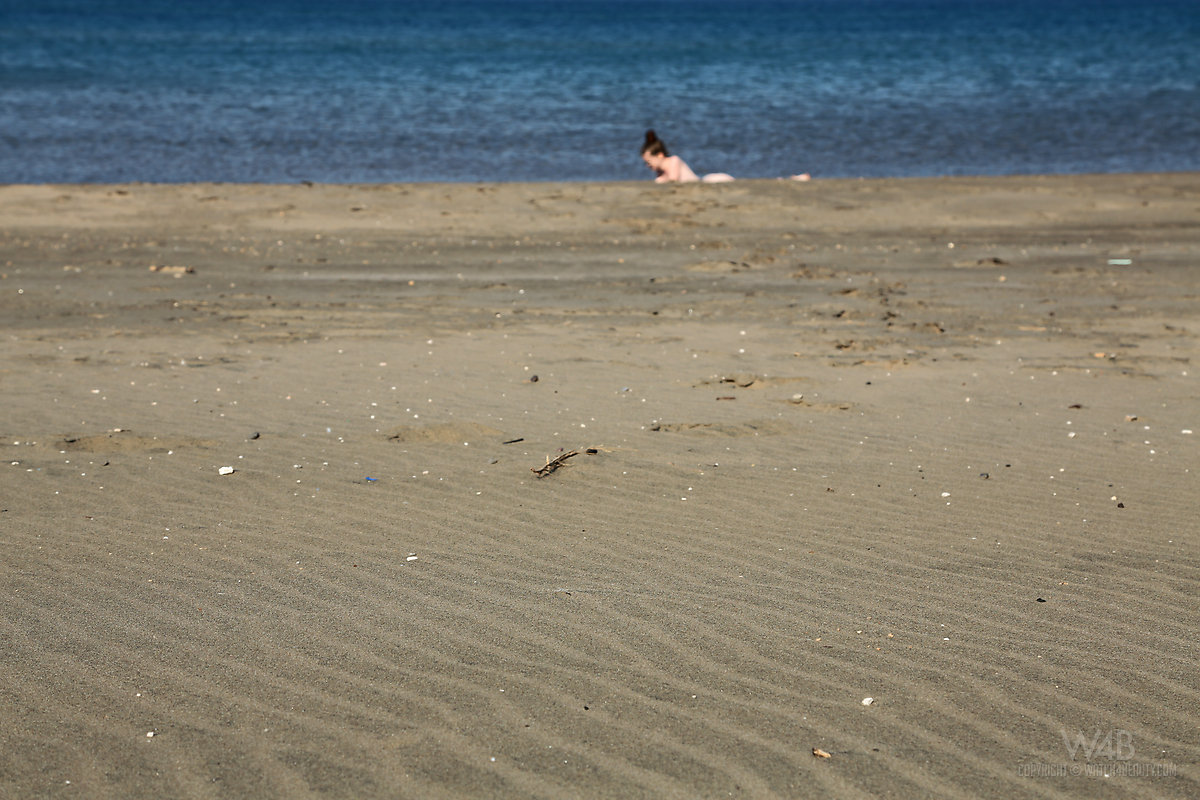 Beach beauty Emily sunbathing naked on the sand spreading long legs wide open porn photo #426852132