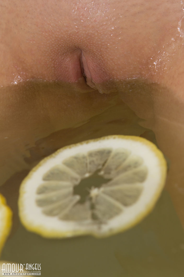 Cute blonde teen sinks her bald twat into a tub filled with lemon slices photo porno #424670665