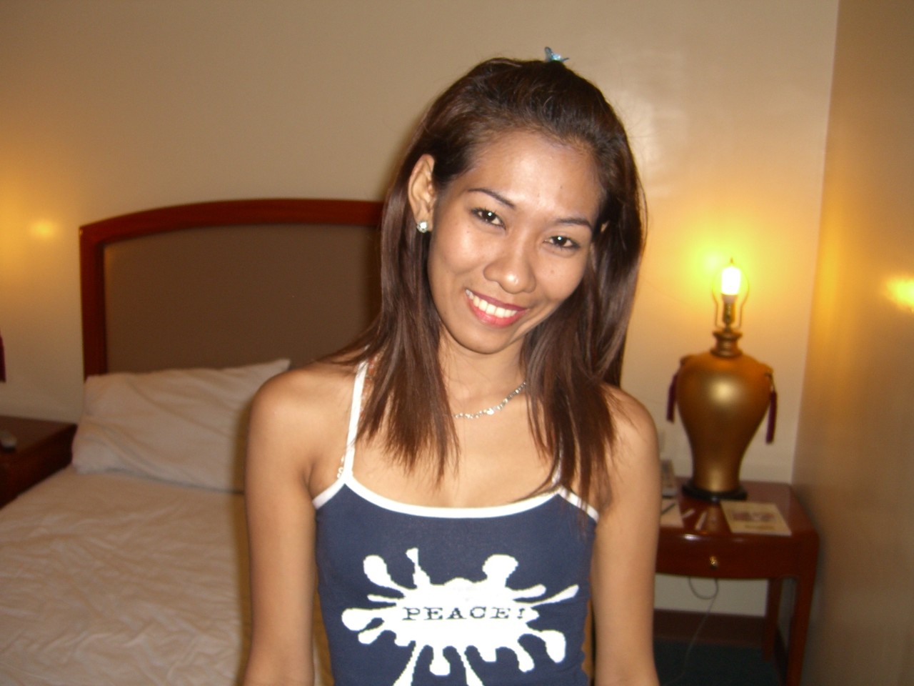 An Asian woman experiences her first nude experience on white sheets.