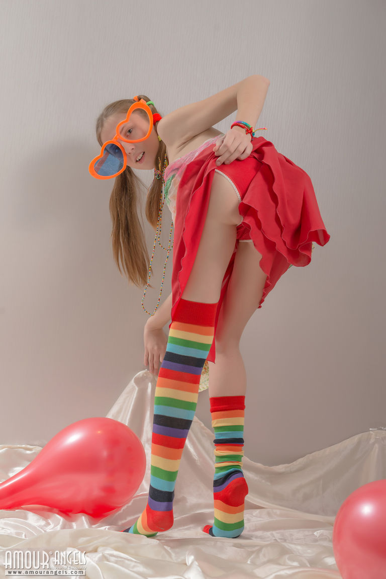 Skinny teen girl in pigtails and multi-colored socks takes off her clothes foto porno #424505229