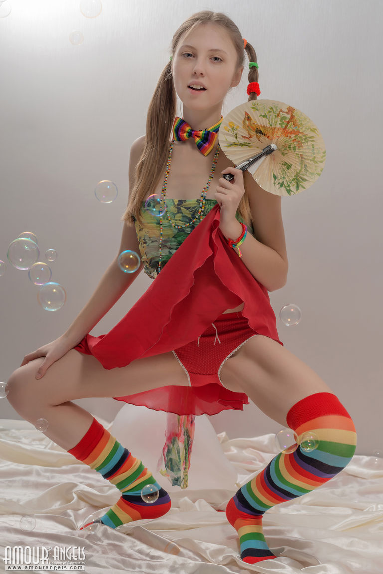 Skinny teen girl in pigtails and multi-colored socks takes off her clothes foto porno #424505235