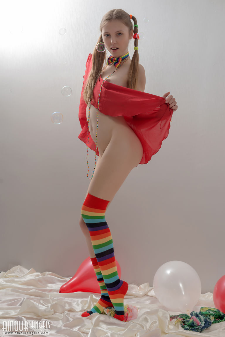 Skinny teen girl in pigtails and multi-colored socks takes off her clothes foto porno #424505255