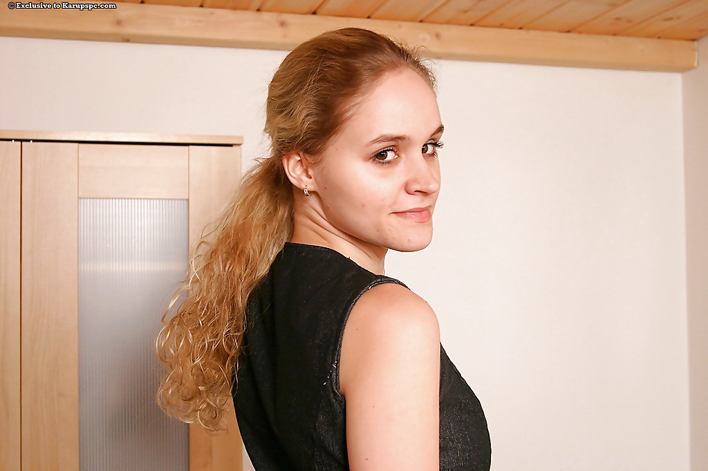 Extensive amateur with a clean-shaved face, undressing, and spreading her legs.