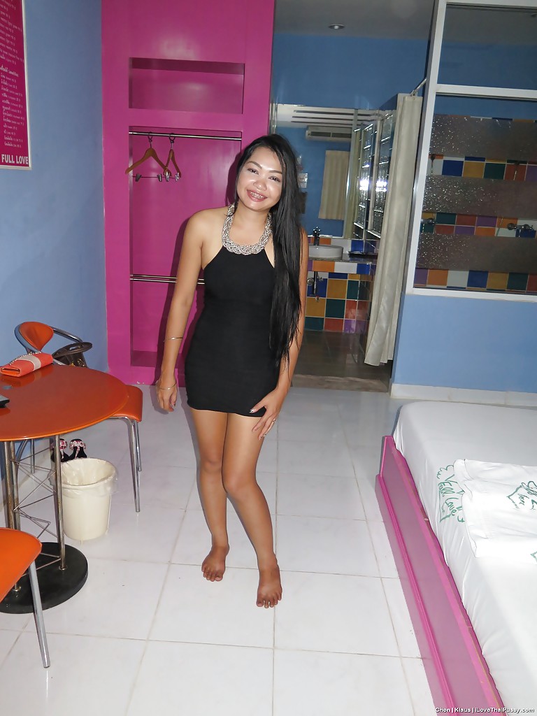 This photo features a young Thai barmaid showing off her newly-shaven Bangkok pussy.