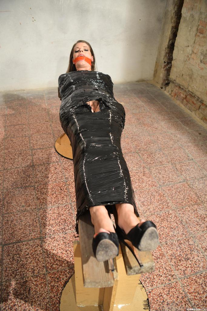Naked female in high heeled shoes only is mummified in plastic and gagged photo porno #428306227