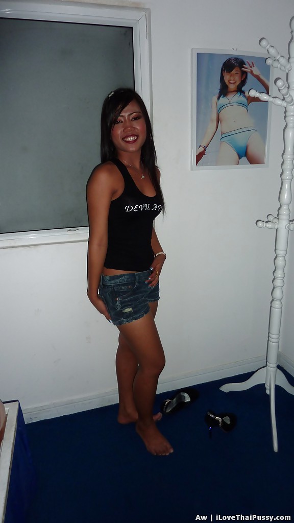 With a seductive appearance, this Asian girl with skinny legs poses in jeans shorts and black top for a photo.