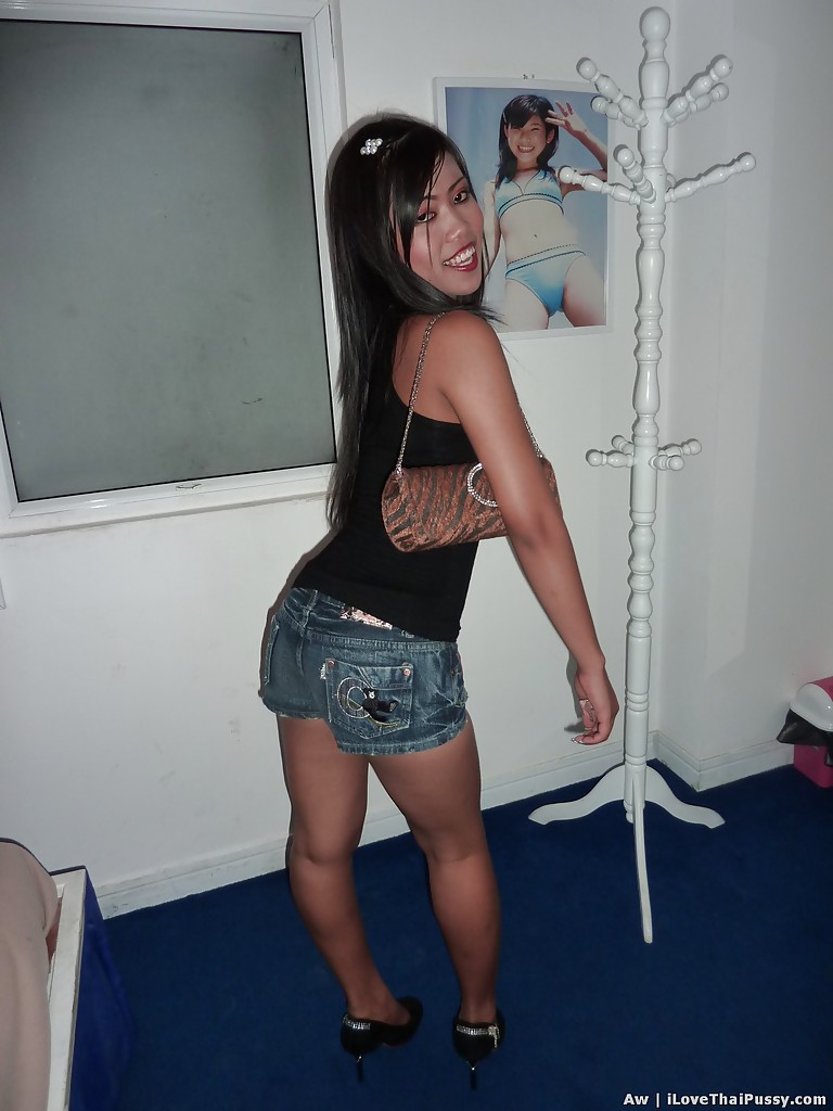 Donning jeans shorts and a black top, this Asian female looks seductive with her slim legs.