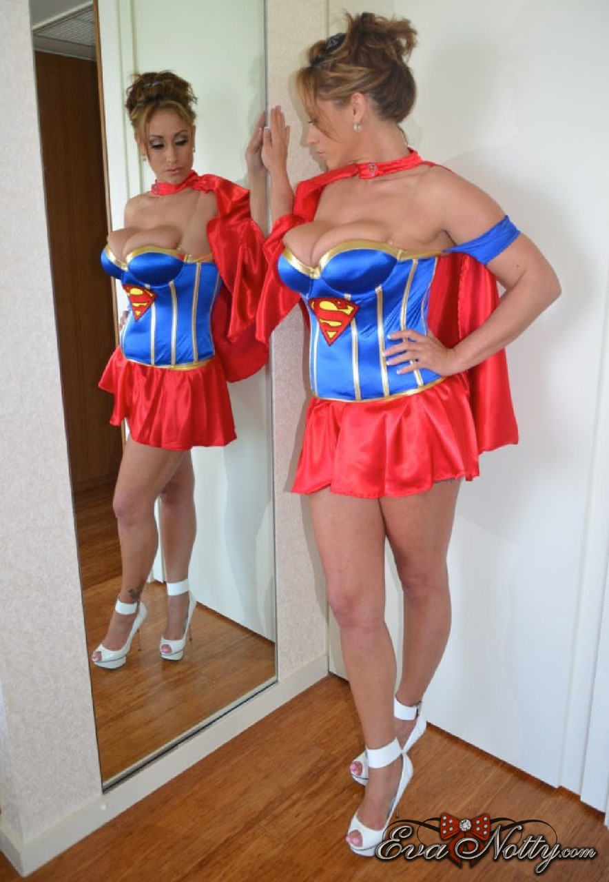 Curvaceous Brunette In A Supergirl Costume Eva Notty Squeezes Her Huge Juggs