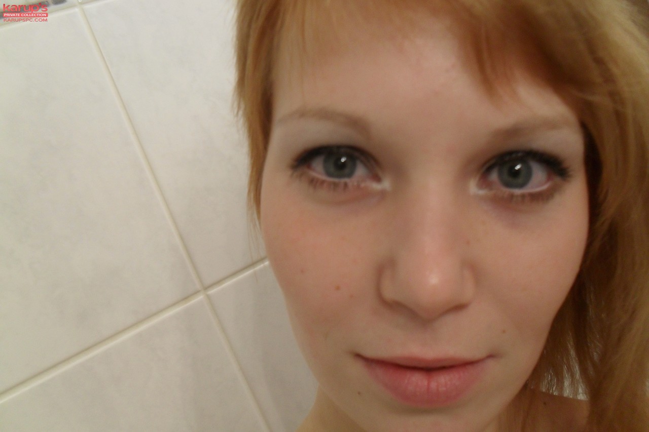 Amateur teen Electra Angel takes a photo of her body while showering herself