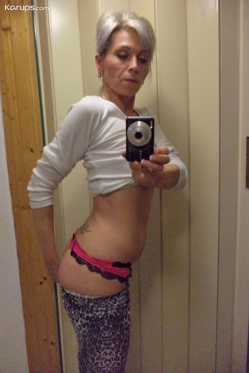 Czech lady Kathy White taking selfies in the mirror while stripping photo