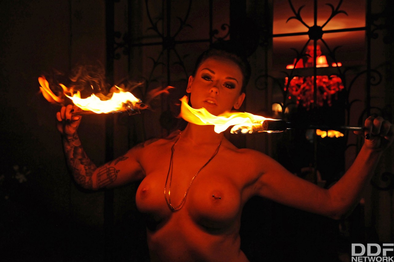 Femdom Daniela gives an outdoor fire-play performance with her big boobs bared porn photo #426935235