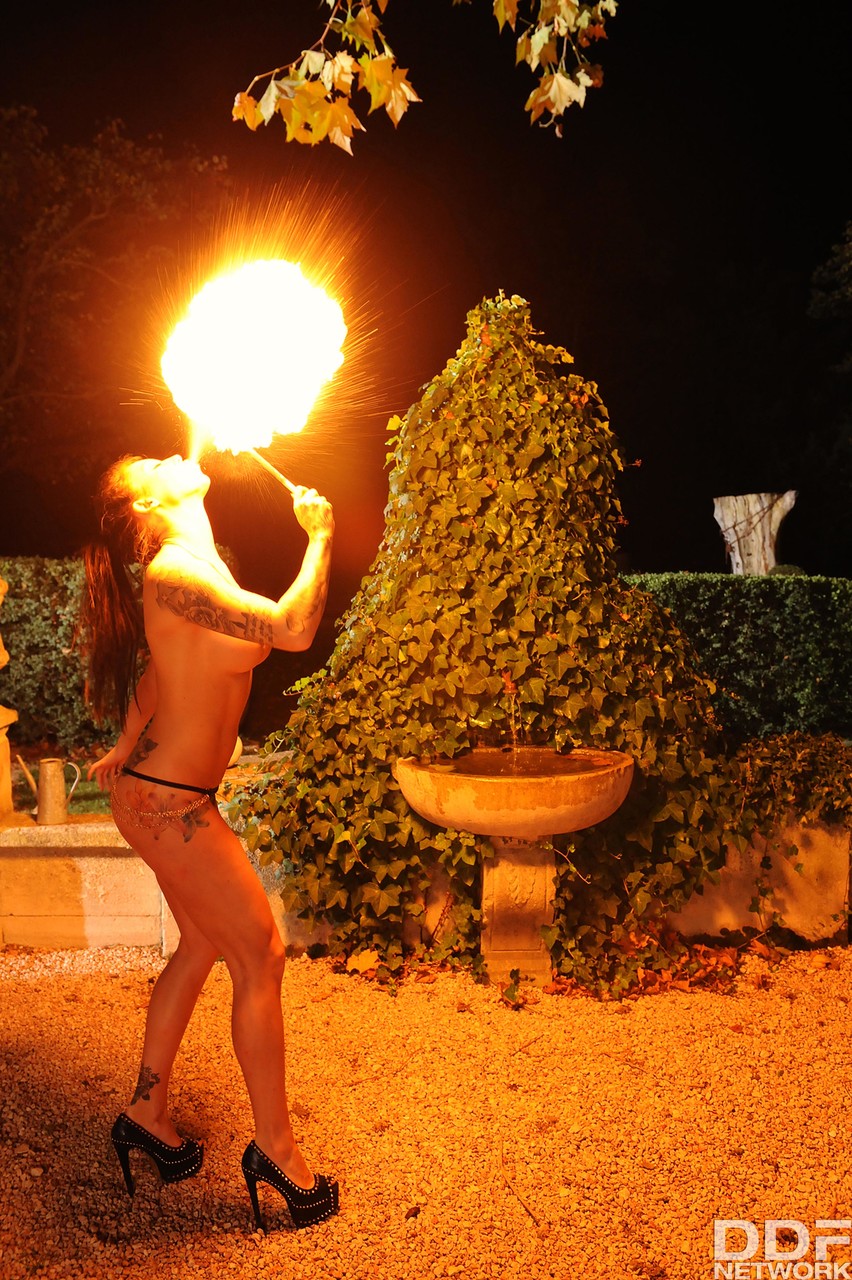 Femdom Daniela gives an outdoor fire-play performance with her big boobs bared foto porno #426935258