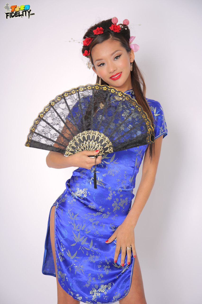 Exhibiting her slim physique, Alina Li is a stunning young Asian who dons traditional attire to showcase her body shape.