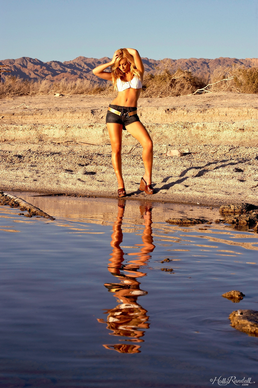 Slender centerfold Kayden Kross strips her clothing to squat naked in the sand порно фото #429049801