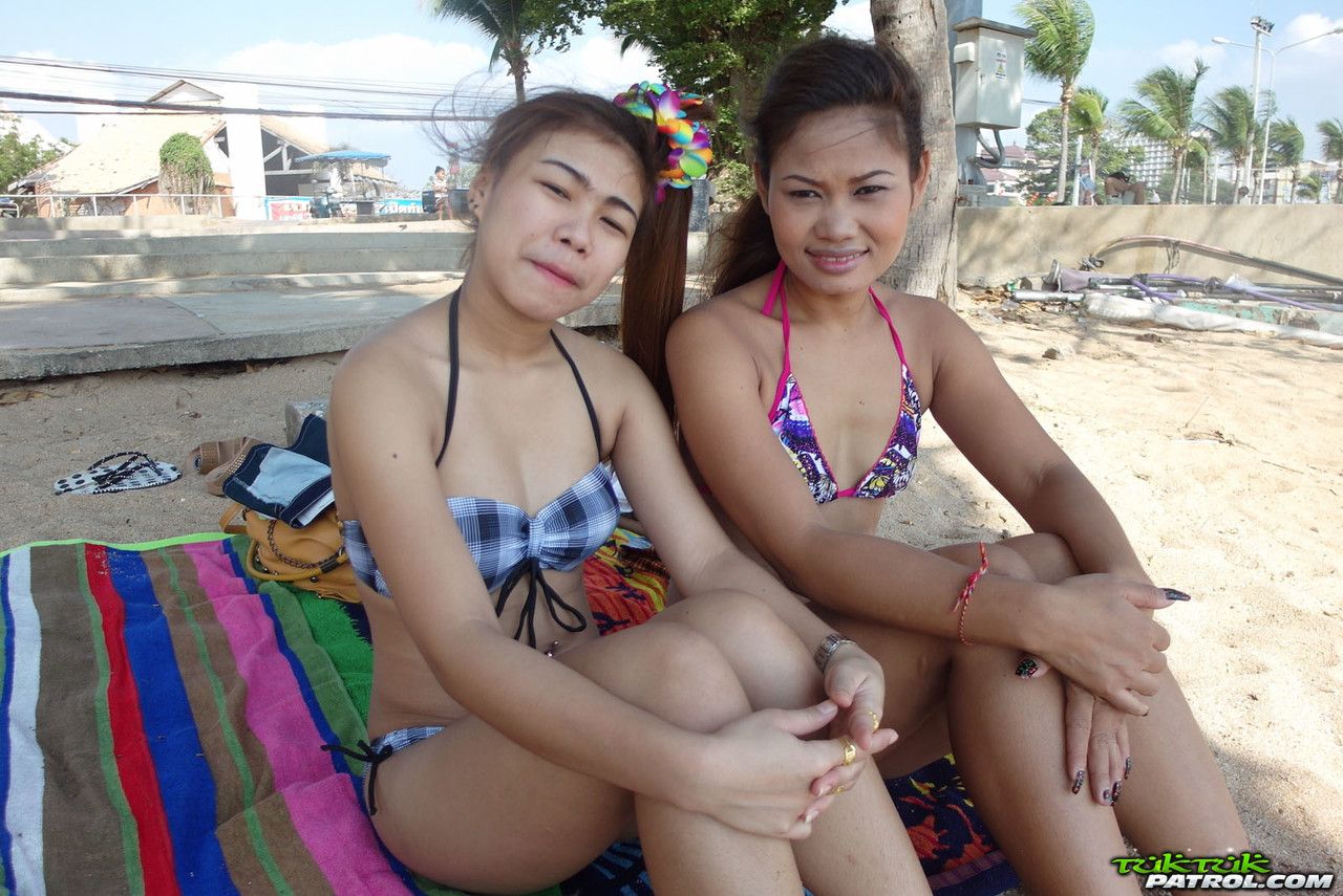 At the beach, young Thai duo Bee and Miaw are seen in slick bikinis with delicious food.