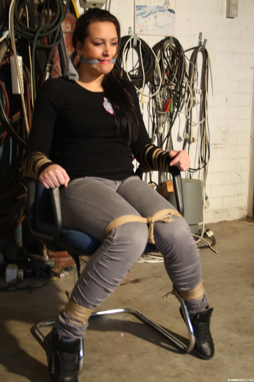 Clothed female struggles against her restraints and mouth gag in a chair foto porno #428284662