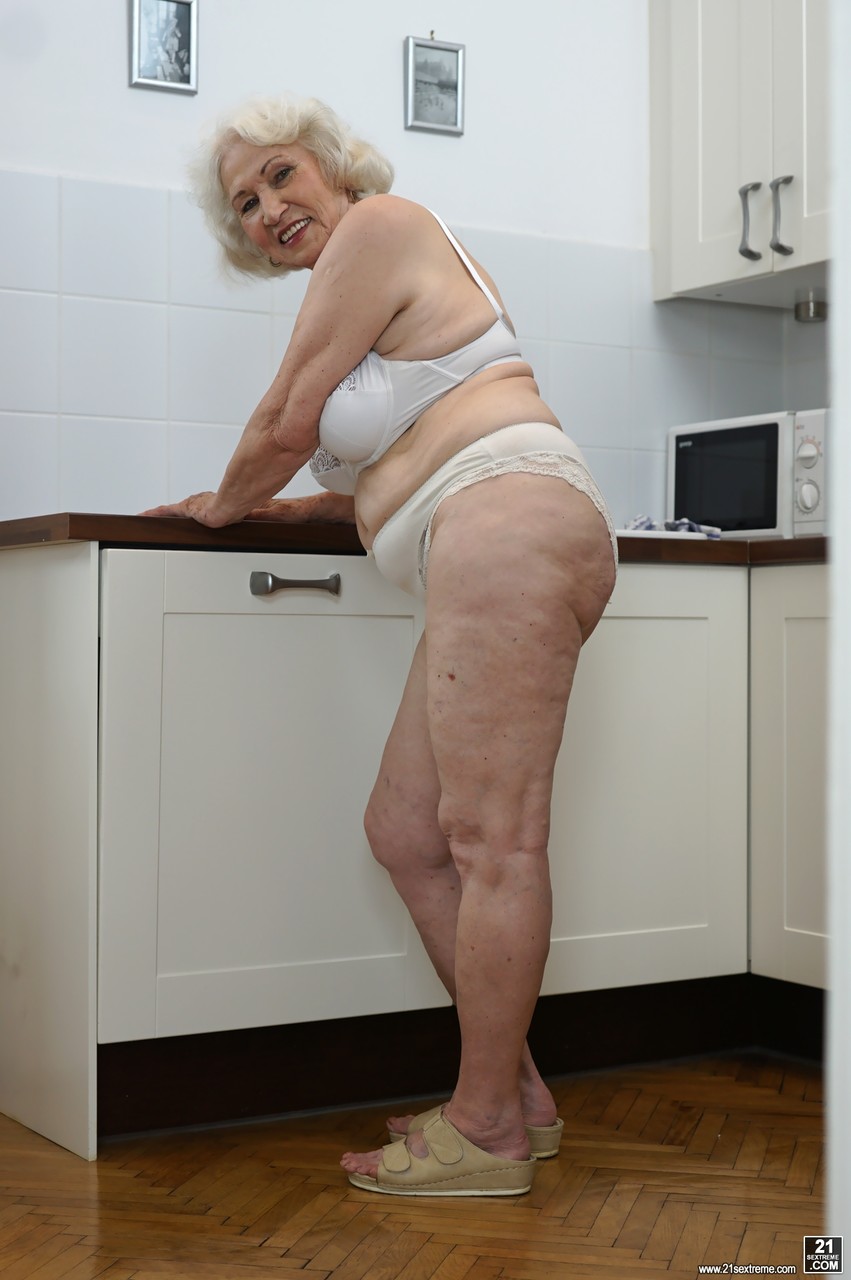 Freaky old blonde granny named Norma showing her tits in the kitchen porn photo #423876067