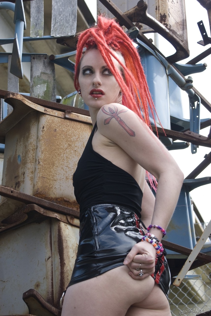 Punk girl with red hair poses nude in platform boots at industrial site foto porno #427909567