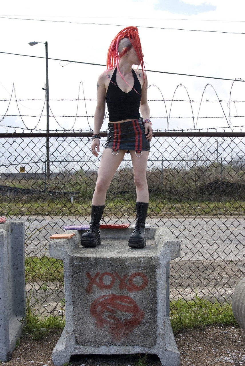 Punk girl with red hair poses nude in platform boots at industrial site foto porno #426872754