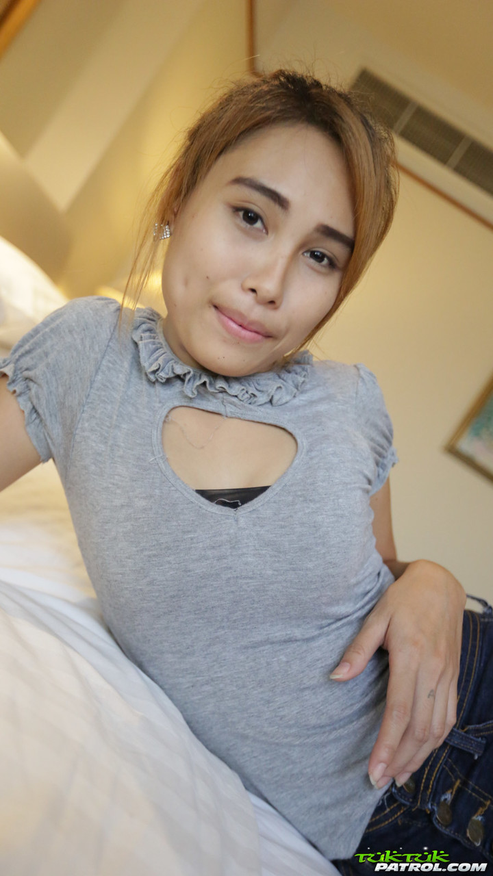 Young Thai girl in braces bares her small tits and neatly trimmed twat on bed porn photo #424261687