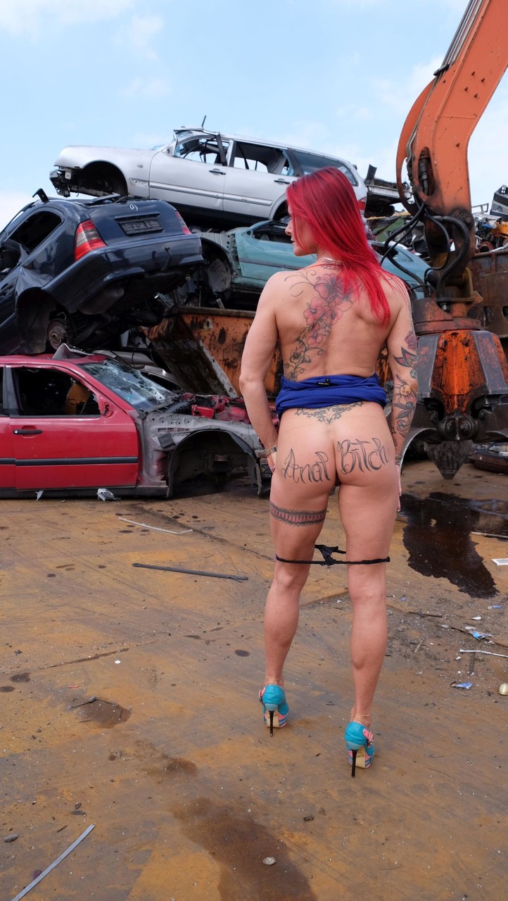 Redhead MILF with tattoos and fake tits gets banged in a junk yard 3some porno fotoğrafı #428323966