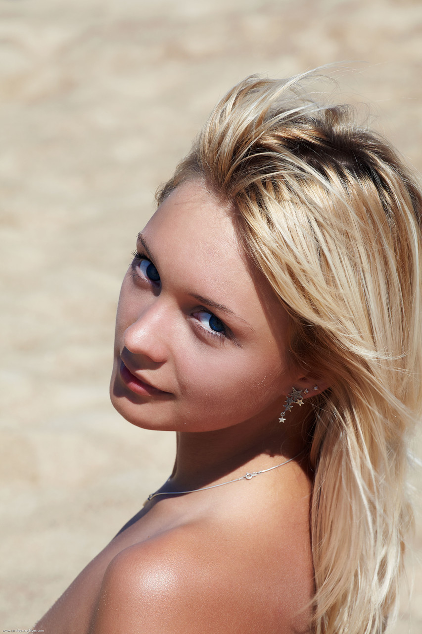 Adorable blonde Lada displays her beautiful shaved pussy on a sandy beach foto porno #424768200