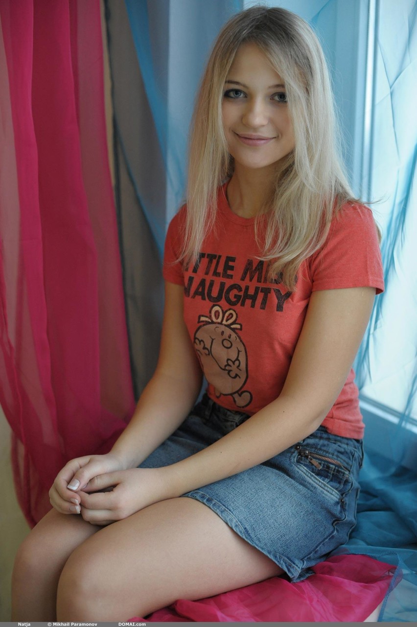 Sweet blonde teen Natja gets naked by a window in a casual manner 포르노 사진 #426012723