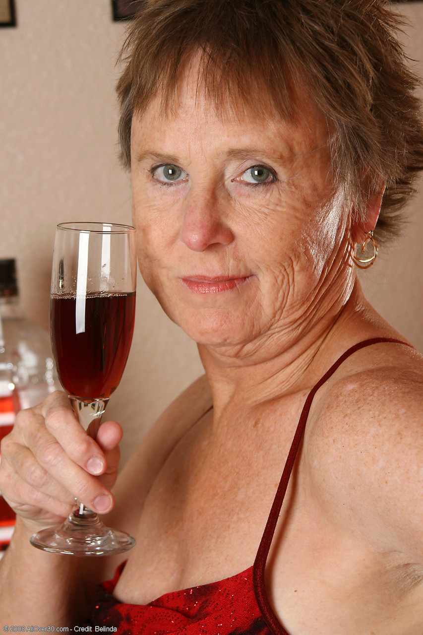 Old granny with big tits Sandra D doffs her red dress and poses nude porn photo #423890582