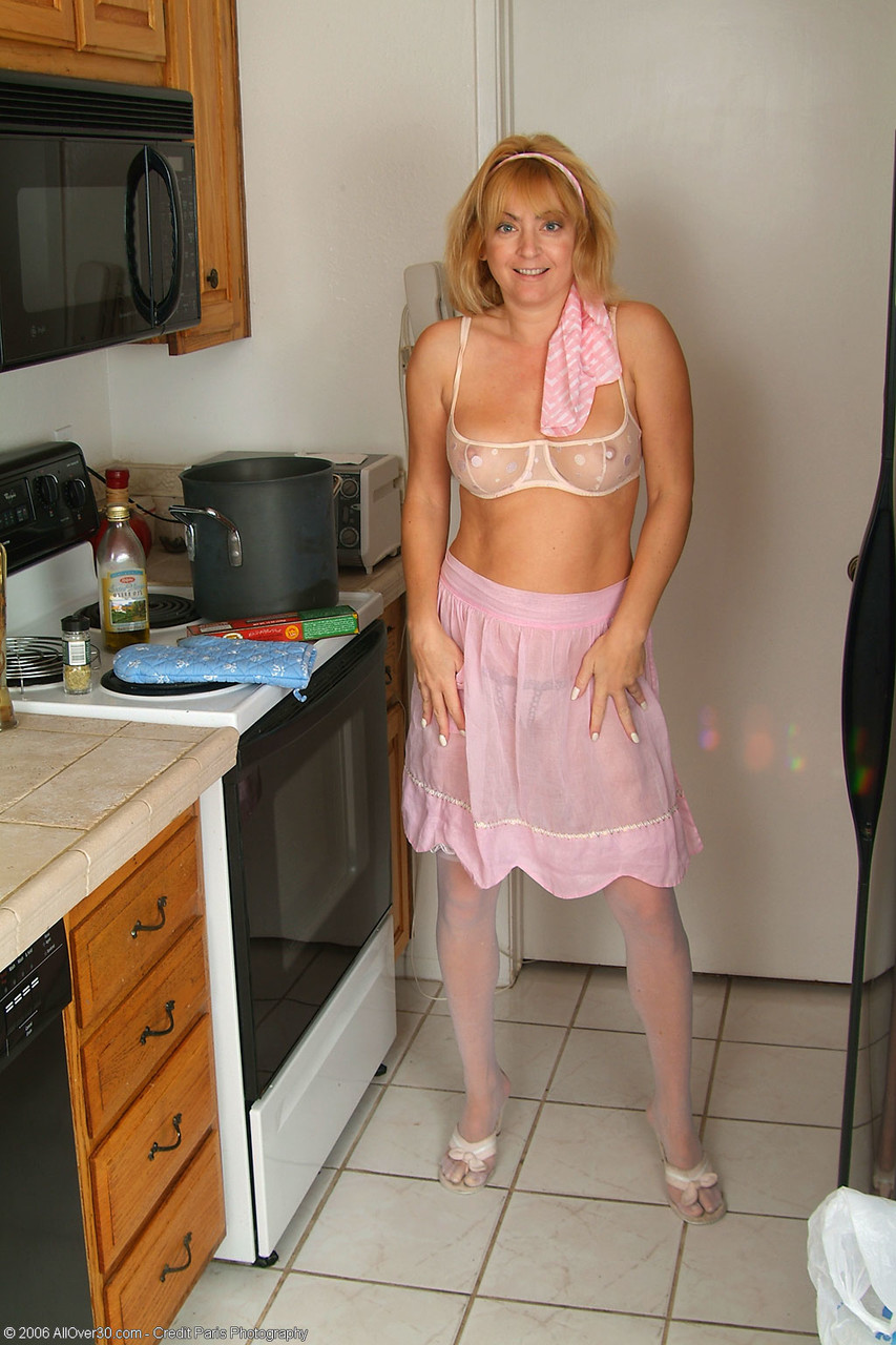 Redheaded Housewife Trixie Poses In Her Lingerie Masturbates While Cooking
