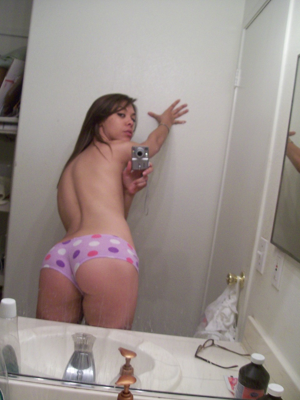 The average young adult displays her attractive genitalia while taking nude selfies.