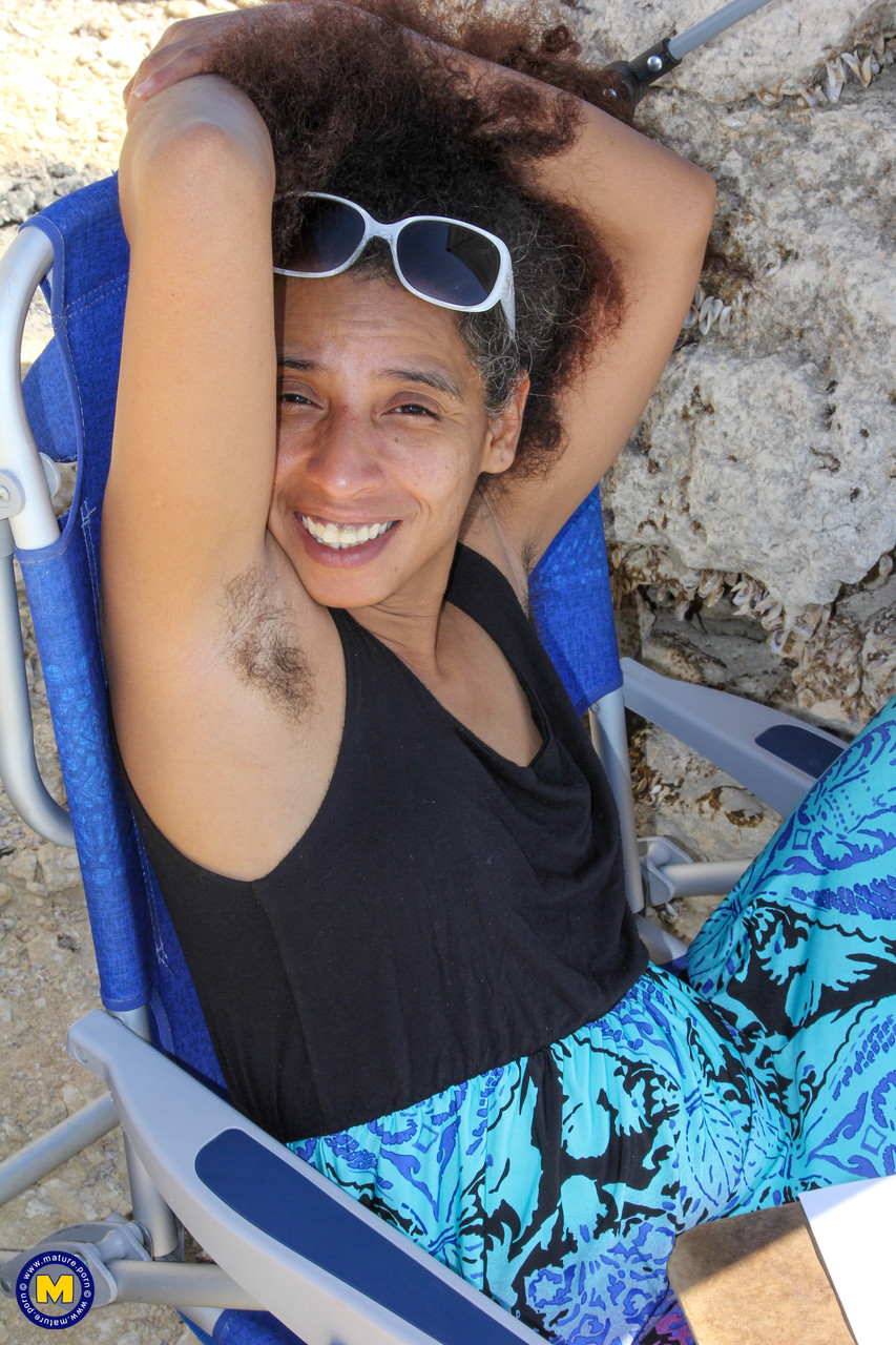 Mature ebony with hairy armpits Divine reveals her bushy cunt on the beach porn photo #424380457