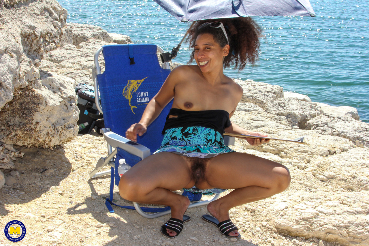 Mature ebony with hairy armpits Divine reveals her bushy cunt on the beach foto porno #424380470