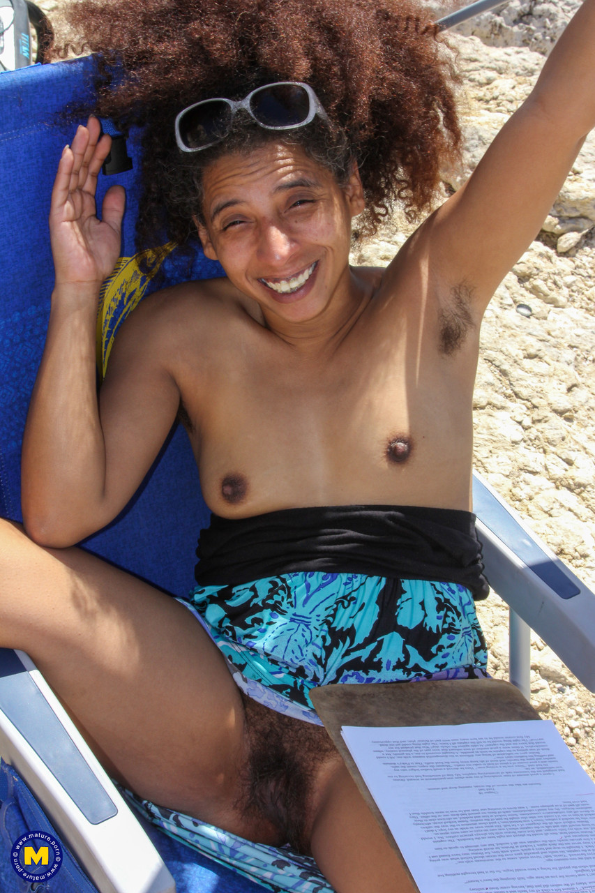 Mature ebony with hairy armpits Divine reveals her bushy cunt on the beach foto porno #424380475