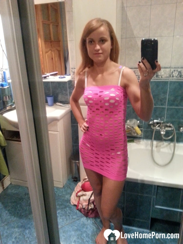 Skinny redheaded amateur hikes up her pink dress & takes selfies in the mirror porn photo #425961052