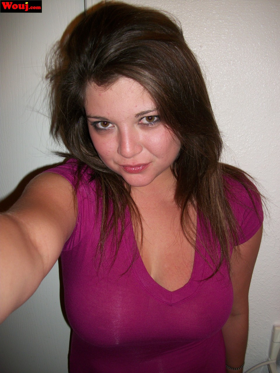 Wearing a shiny pink dress, WouJ showcases her breasts as an amateur brunette.