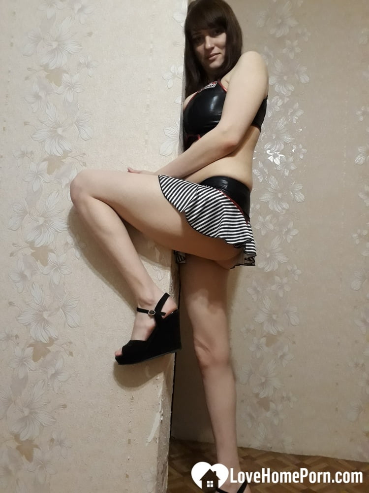 In her bedroom, the mom with breasts flaunting their buttocks and dressed in a suggestive outfit.