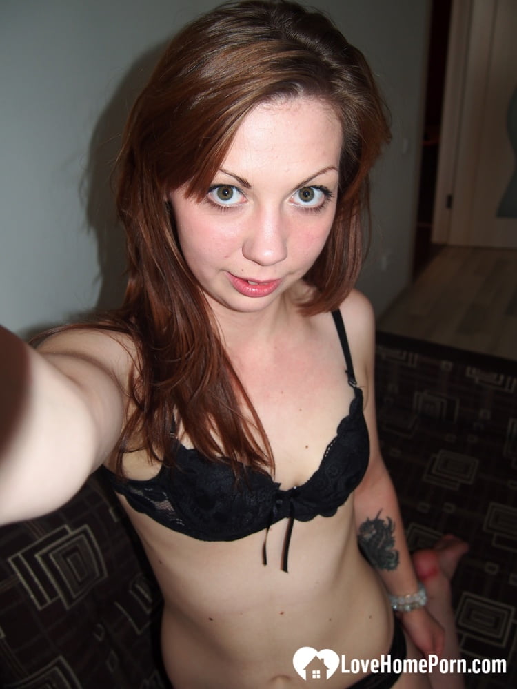 Inked body and small breasts are captured in selfies taken by a charming young woman.