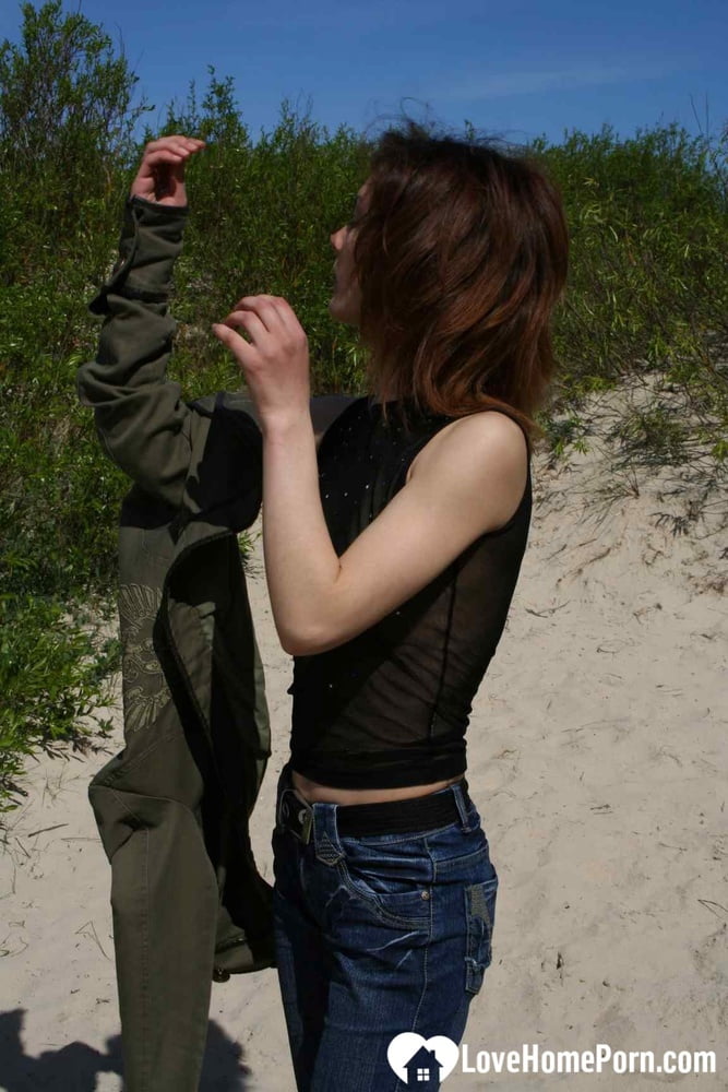 During nature walks, the saucy petite girl strips and displays her breasts as she hikes.