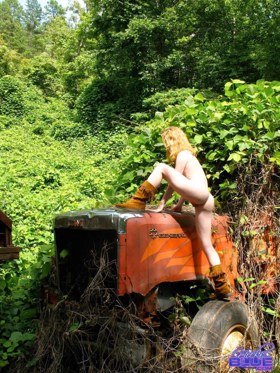Amateur babe in boots Nicki Blue strips and poses on a tractor in the forest foto porno #424040516