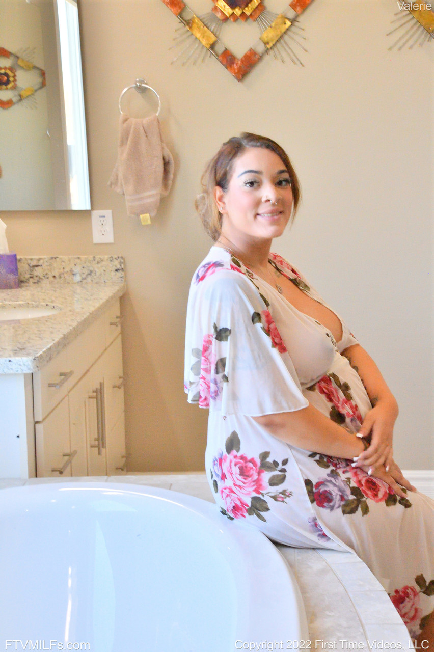 Valerie, who is pregnant with MILF, displays her swollen tits and toys in the bathtub.
