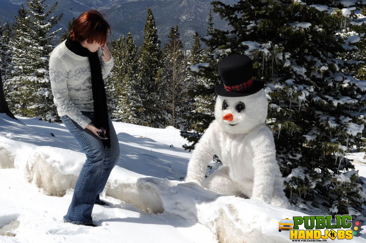 Naughty redhead Brandi de Lafey gives a snowman a CFNM handjob in the woods porno foto #422743160